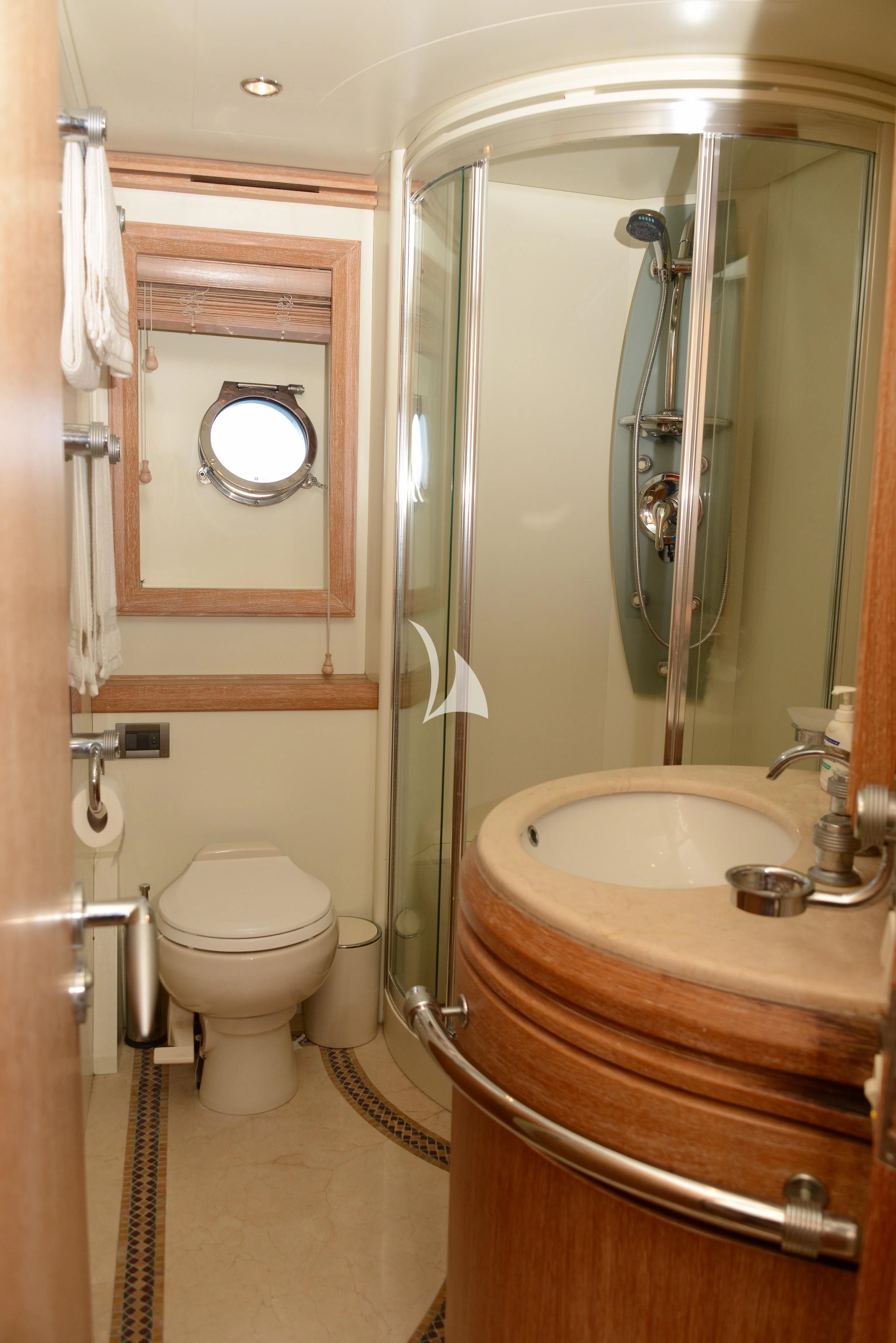 a bathroom with a sink toilet and a mirror aboard OBSIDIAN Yacht for Sale