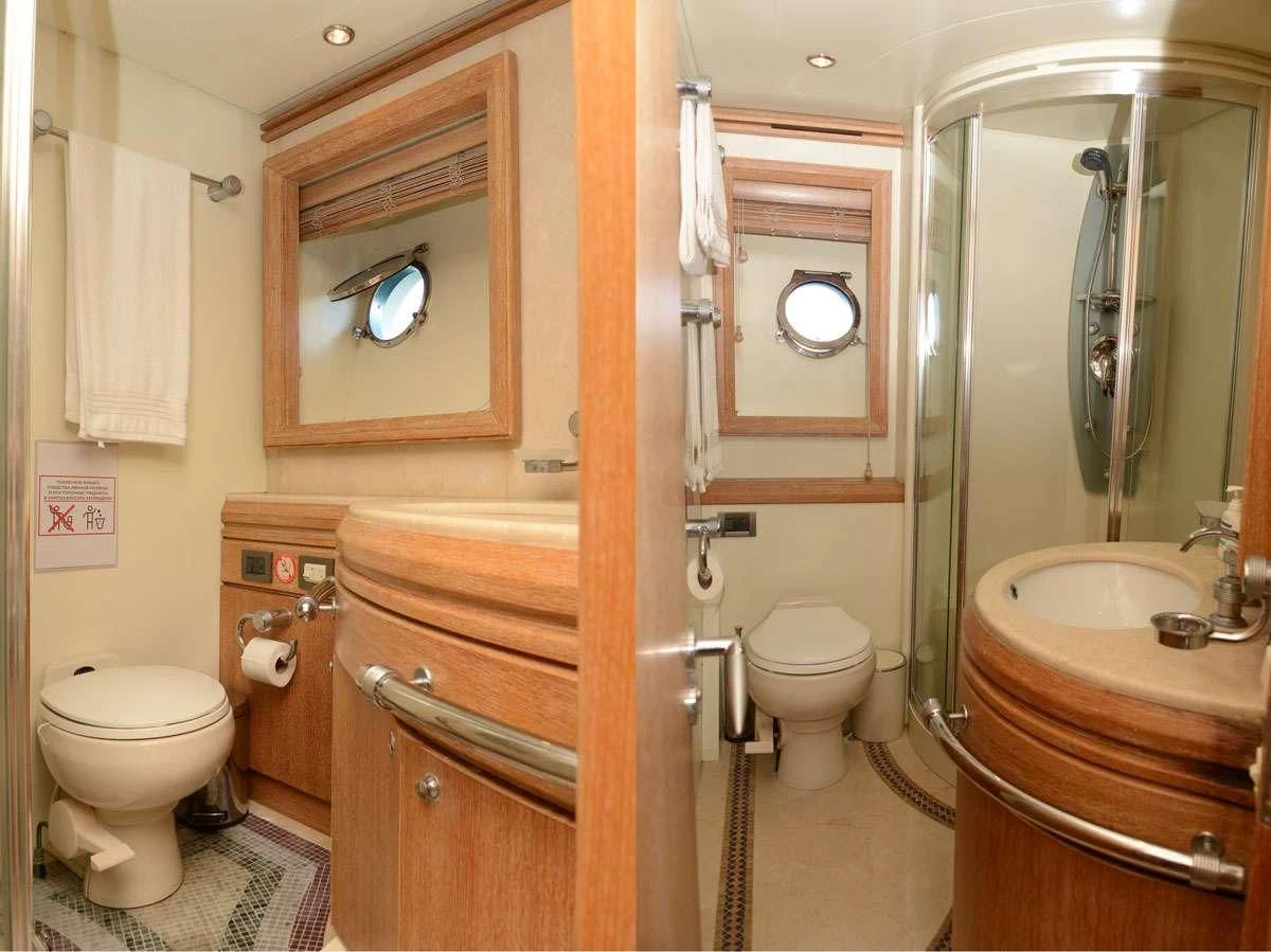 a bathroom with a toilet and sink aboard OBSIDIAN Yacht for Sale