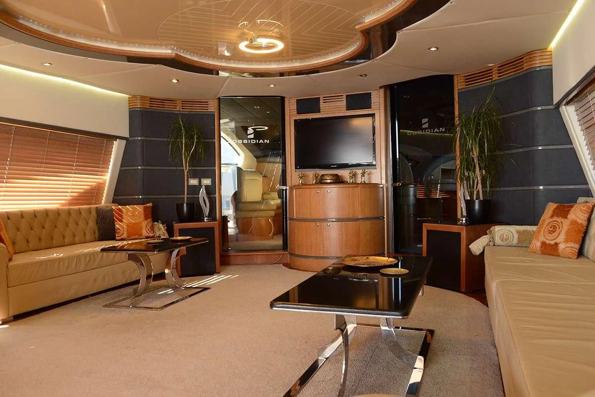 a living room with a large tv aboard OBSIDIAN Yacht for Sale