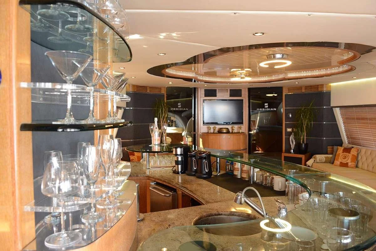 a kitchen with a glass wall aboard OBSIDIAN Yacht for Sale