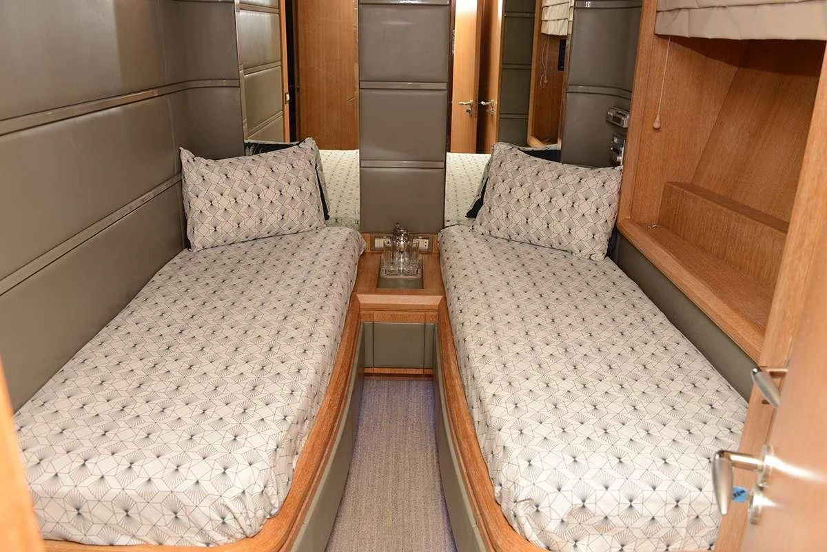 a room with a bed and a table aboard OBSIDIAN Yacht for Sale