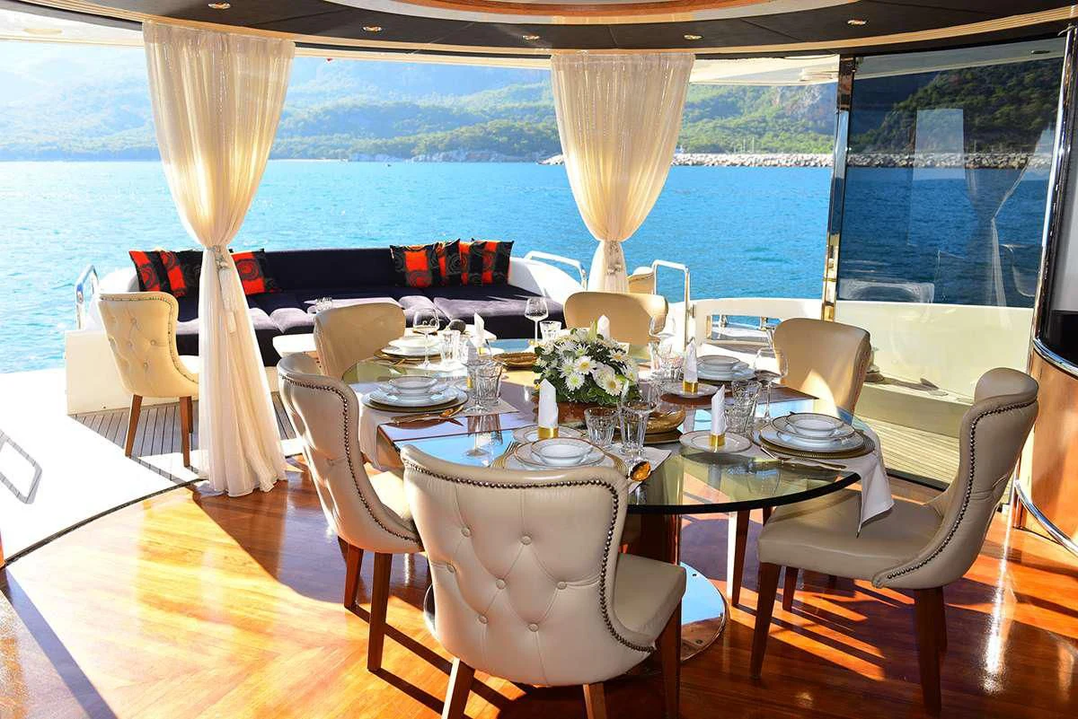 a dining room with a large window aboard OBSIDIAN Yacht for Sale