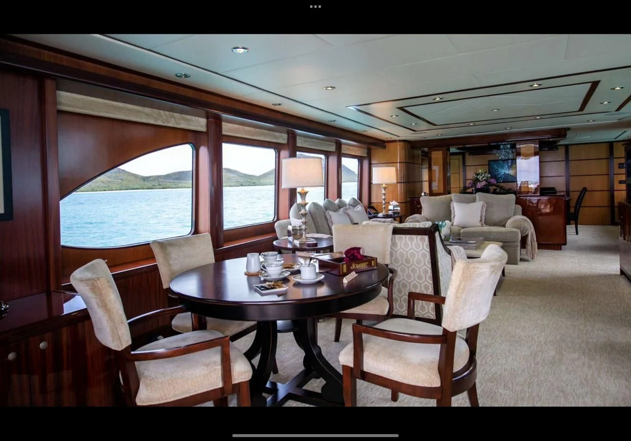 a dining room with a table and chairs aboard JUST ENOUGH Yacht for Charter