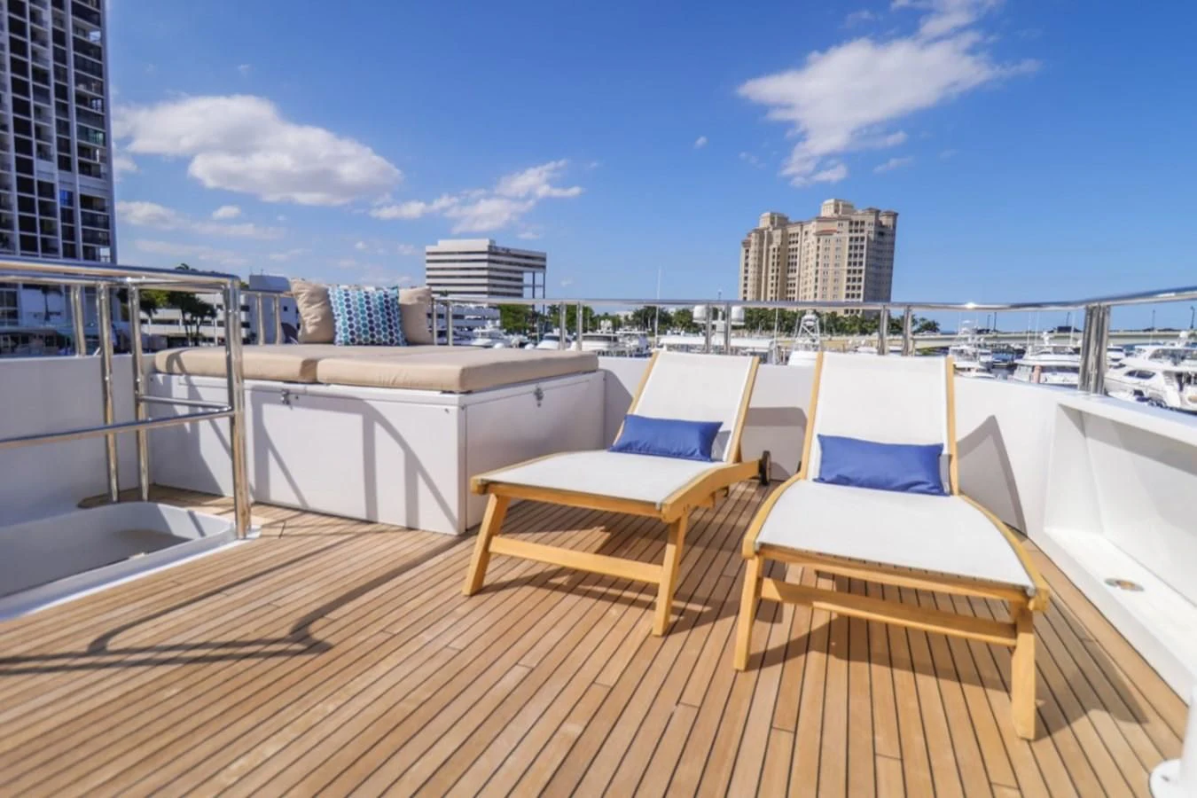 a deck with chairs and a table on it aboard JUST ENOUGH Yacht for Charter