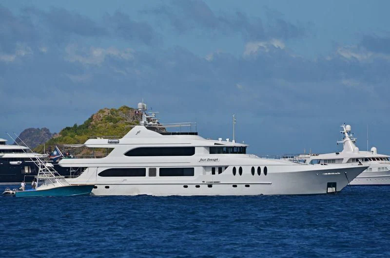 a large white yacht in the water aboard JUST ENOUGH Yacht for Charter