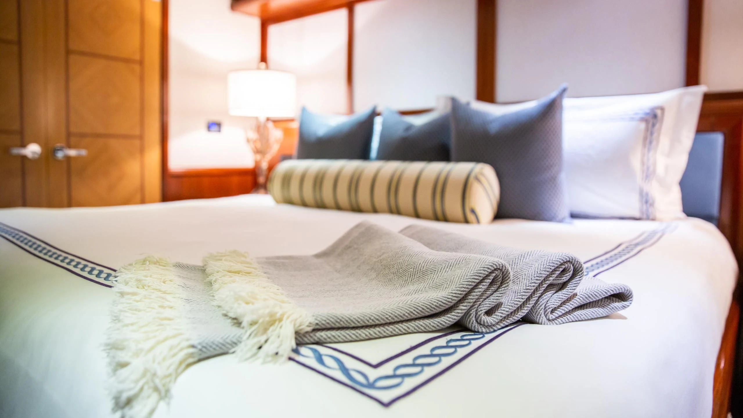 a bed with pillows aboard JUST ENOUGH Yacht for Charter