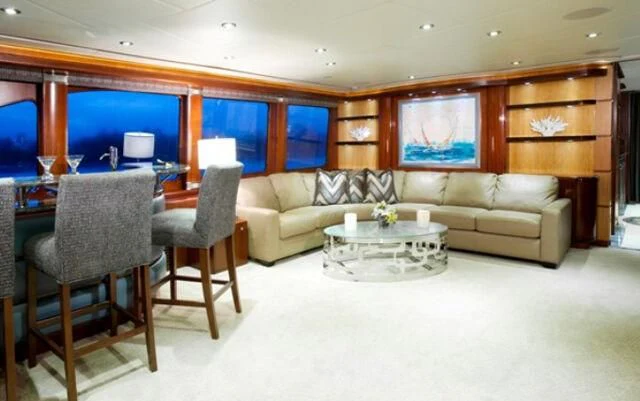 a living room with a couch and a table aboard JUST ENOUGH Yacht for Charter