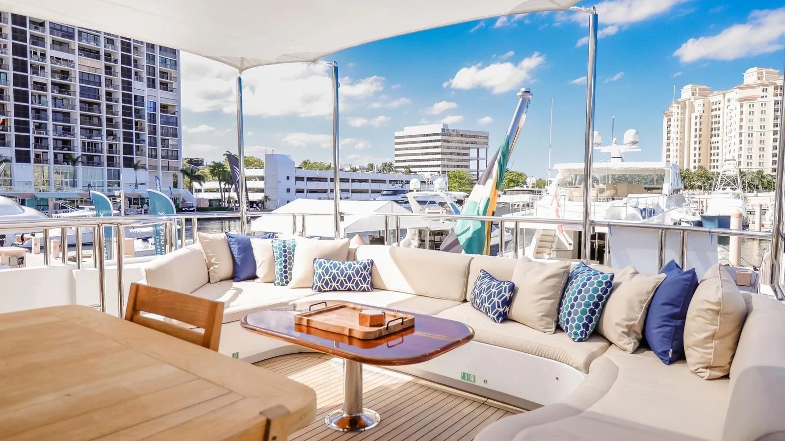 a room with a couch and a table and a view of a city aboard JUST ENOUGH Yacht for Charter