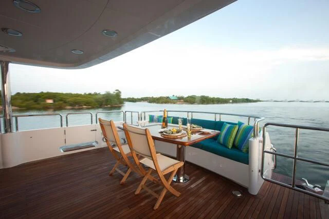 a table and chairs on a deck aboard JUST ENOUGH Yacht for Charter