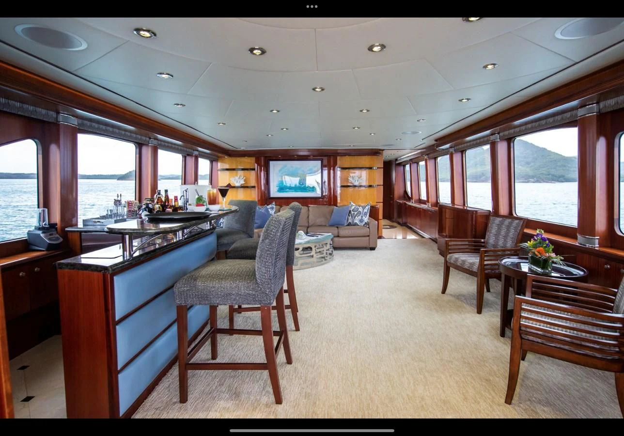 a large living room with a large window aboard JUST ENOUGH Yacht for Charter