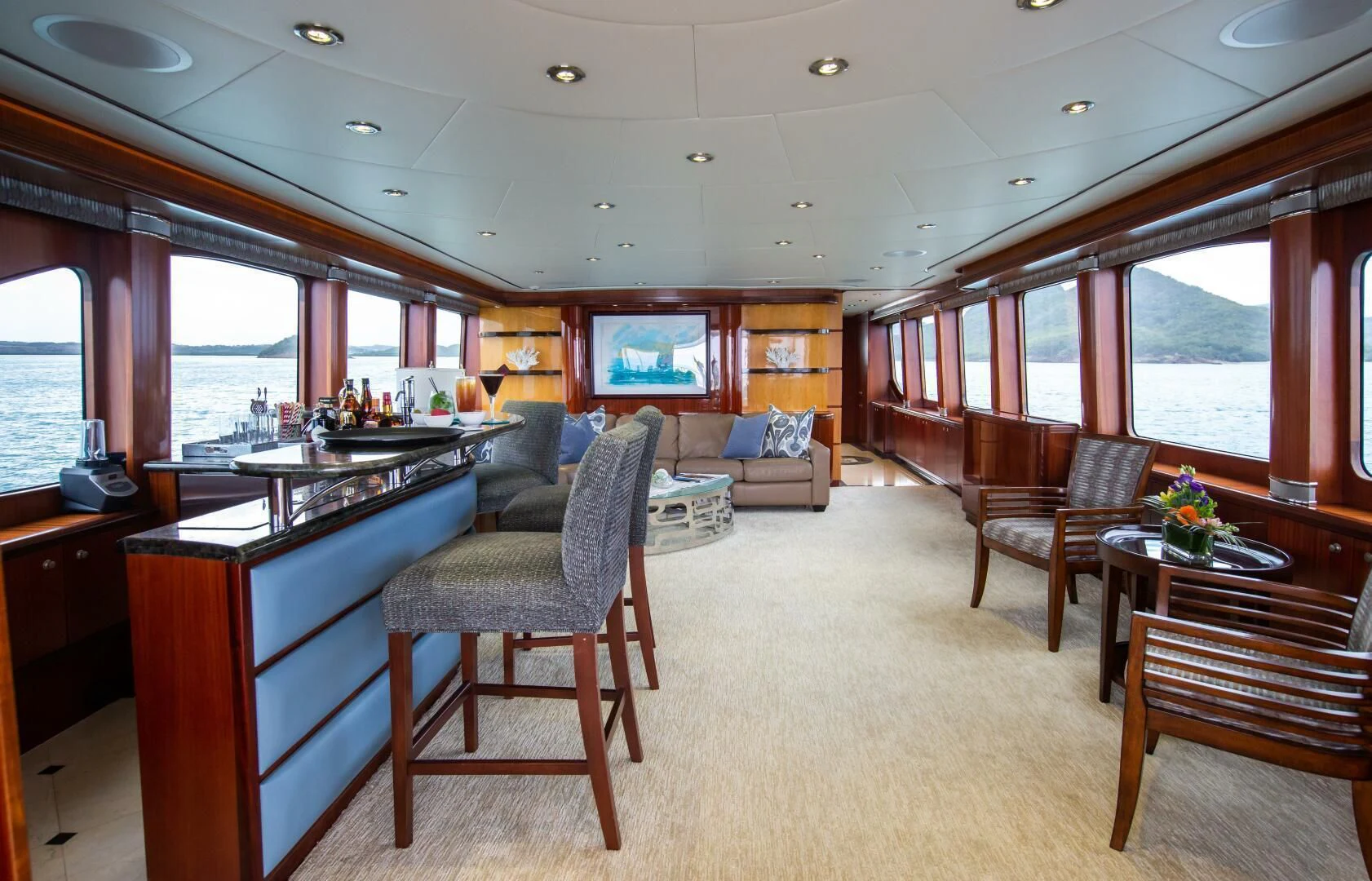 a large living room with a kitchen and dining area aboard JUST ENOUGH Yacht for Charter