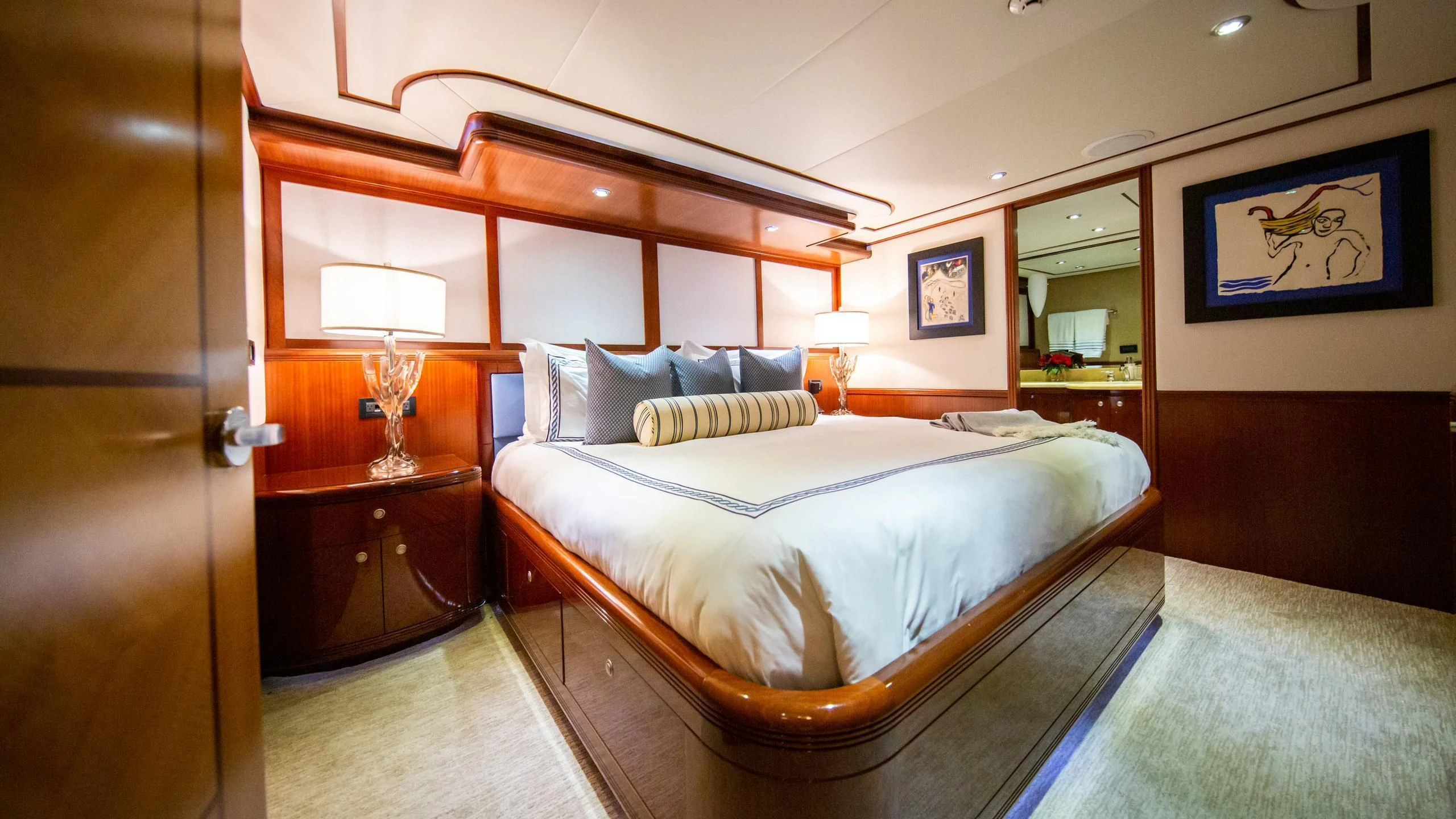a bedroom with a bed and a lamp aboard JUST ENOUGH Yacht for Charter