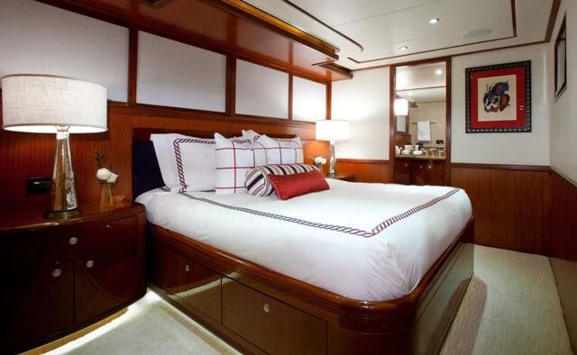 a bedroom with a bed and a desk aboard JUST ENOUGH Yacht for Charter