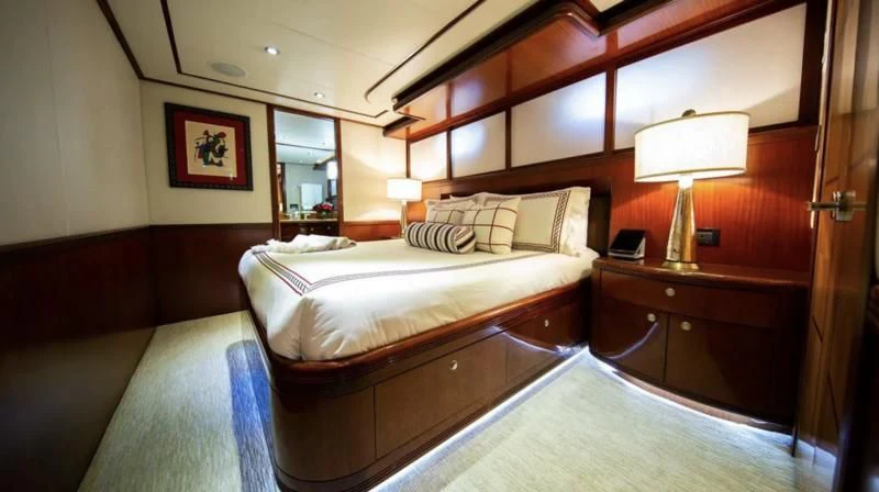 a hotel room with a bed and a desk aboard JUST ENOUGH Yacht for Charter