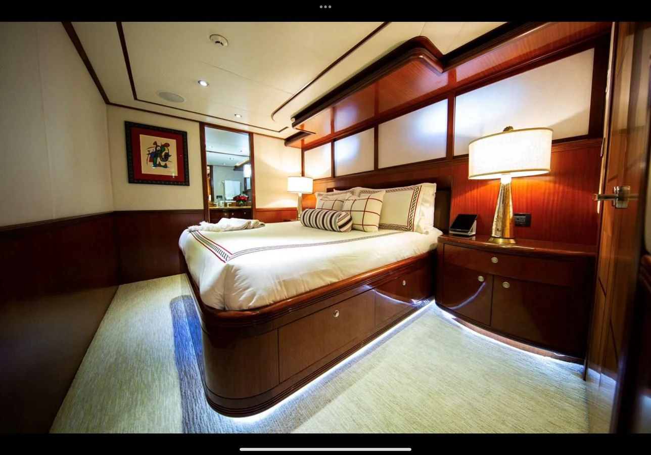 a hotel room with a bed and a lamp aboard JUST ENOUGH Yacht for Charter