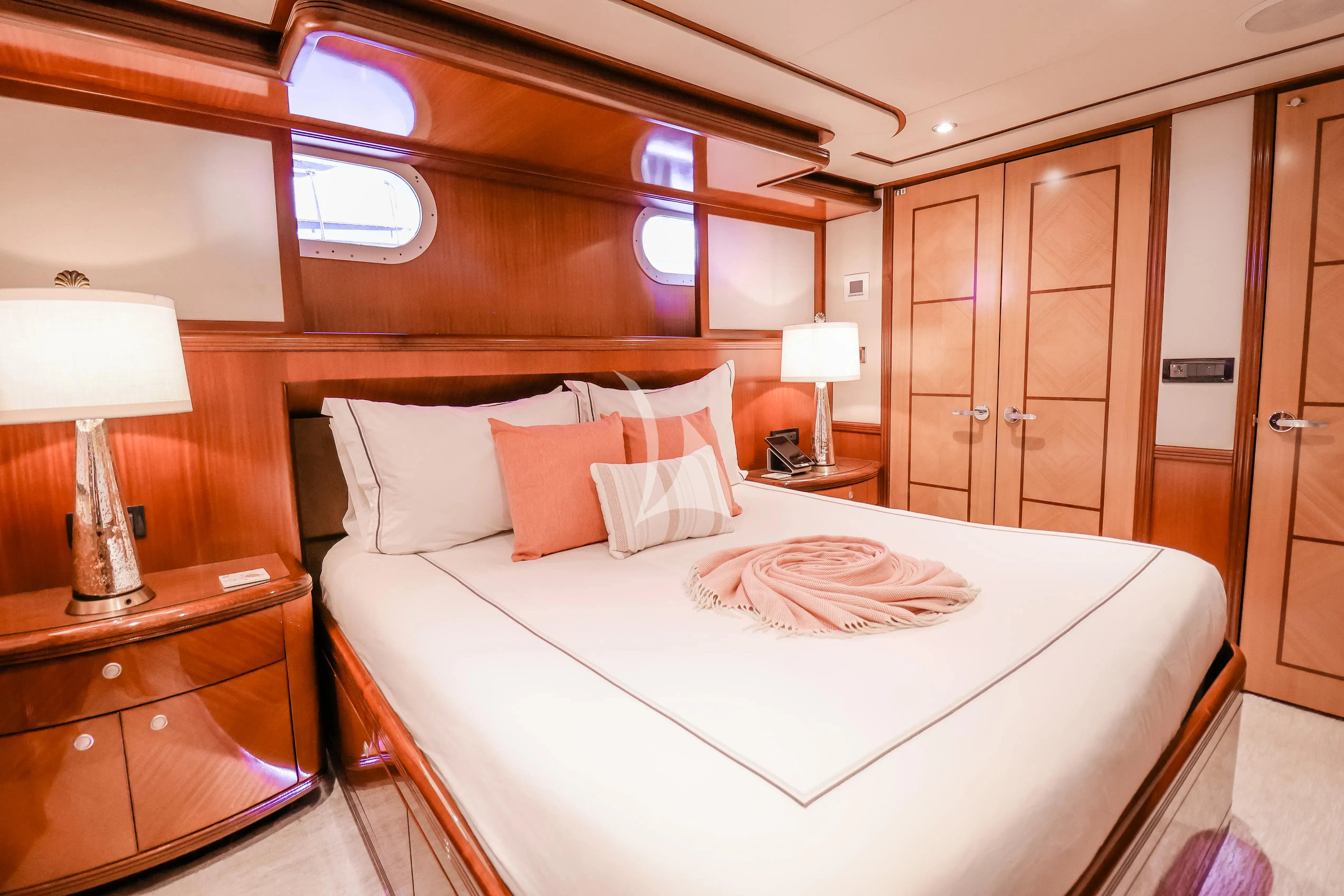 a hotel room with a bed and lamps aboard JUST ENOUGH Yacht for Charter
