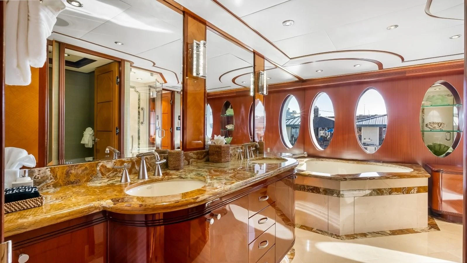 a bathroom with a countertop sink and mirrors aboard JUST ENOUGH Yacht for Charter