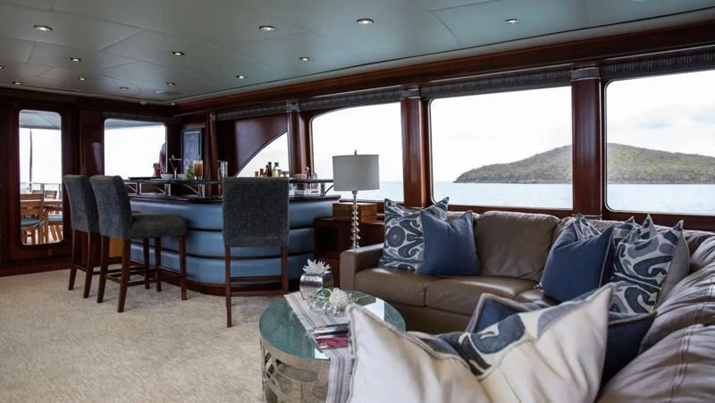 a living room with a couch and a window aboard JUST ENOUGH Yacht for Charter
