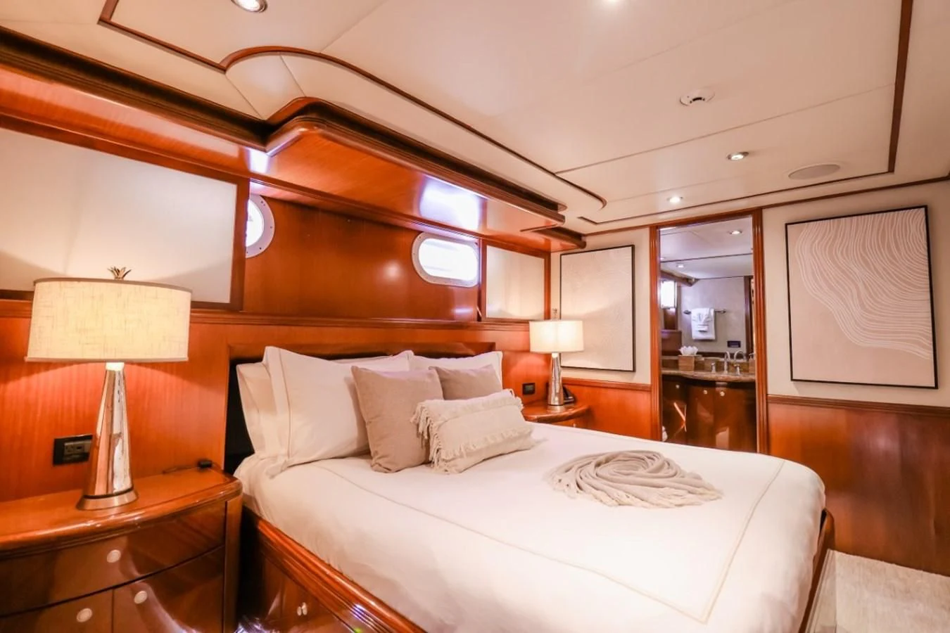 a hotel room with a bed and a table aboard JUST ENOUGH Yacht for Charter
