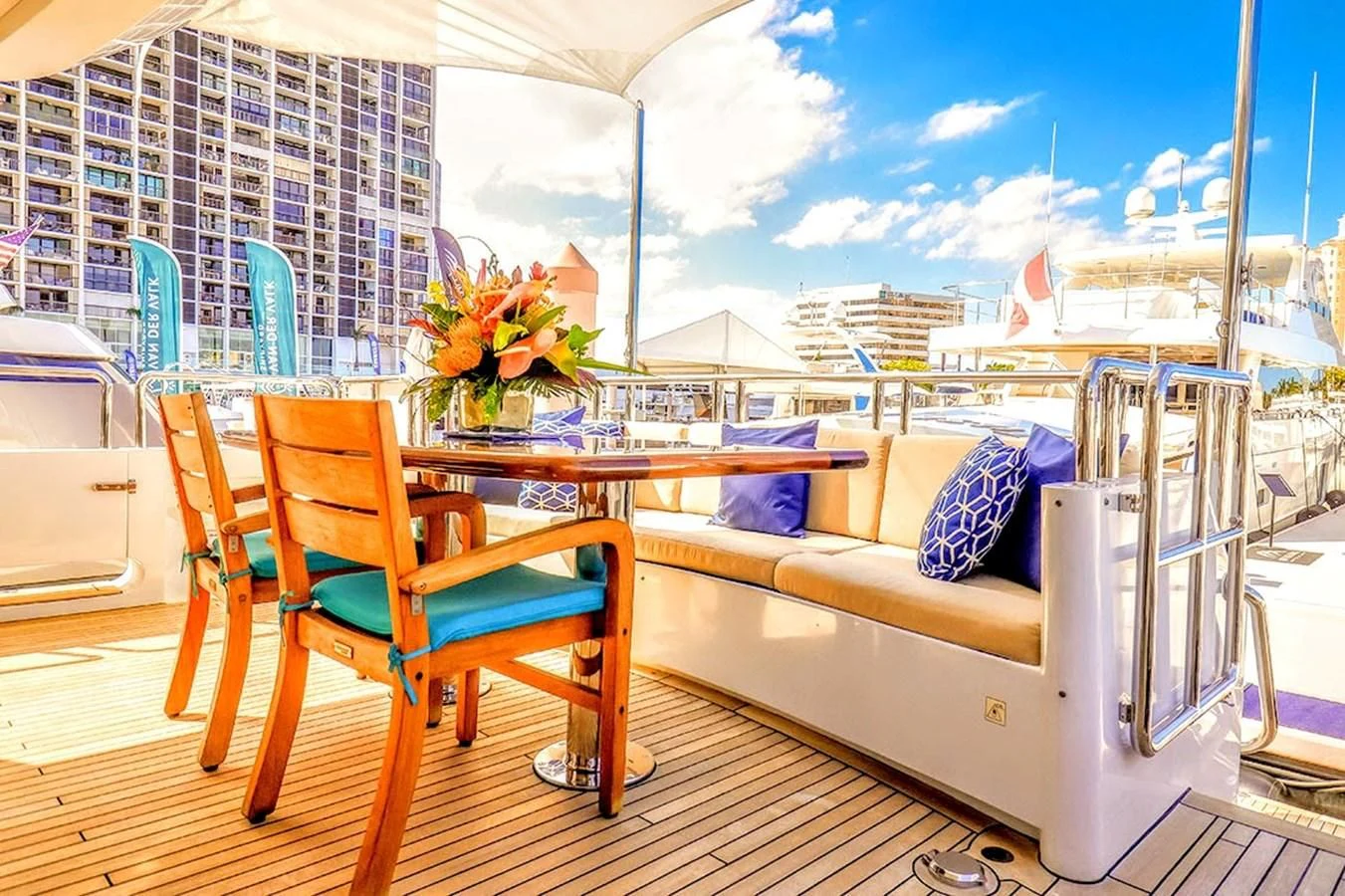 a table and chairs on a balcony aboard JUST ENOUGH Yacht for Charter