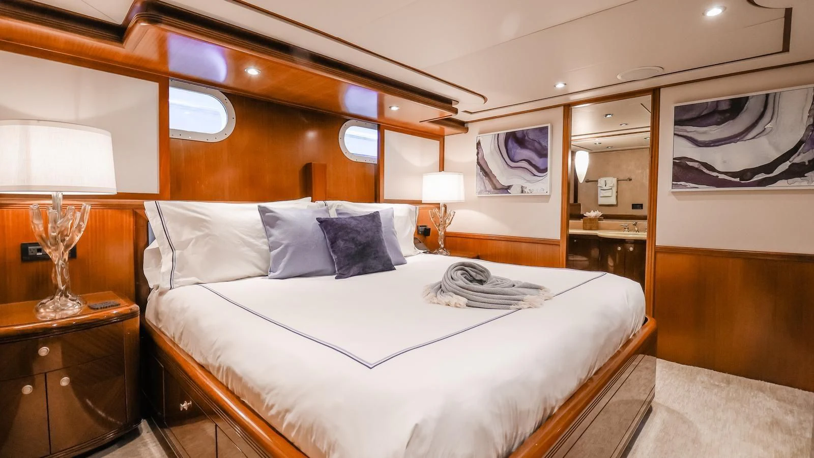 a bed with a white sheet and pillows aboard JUST ENOUGH Yacht for Charter