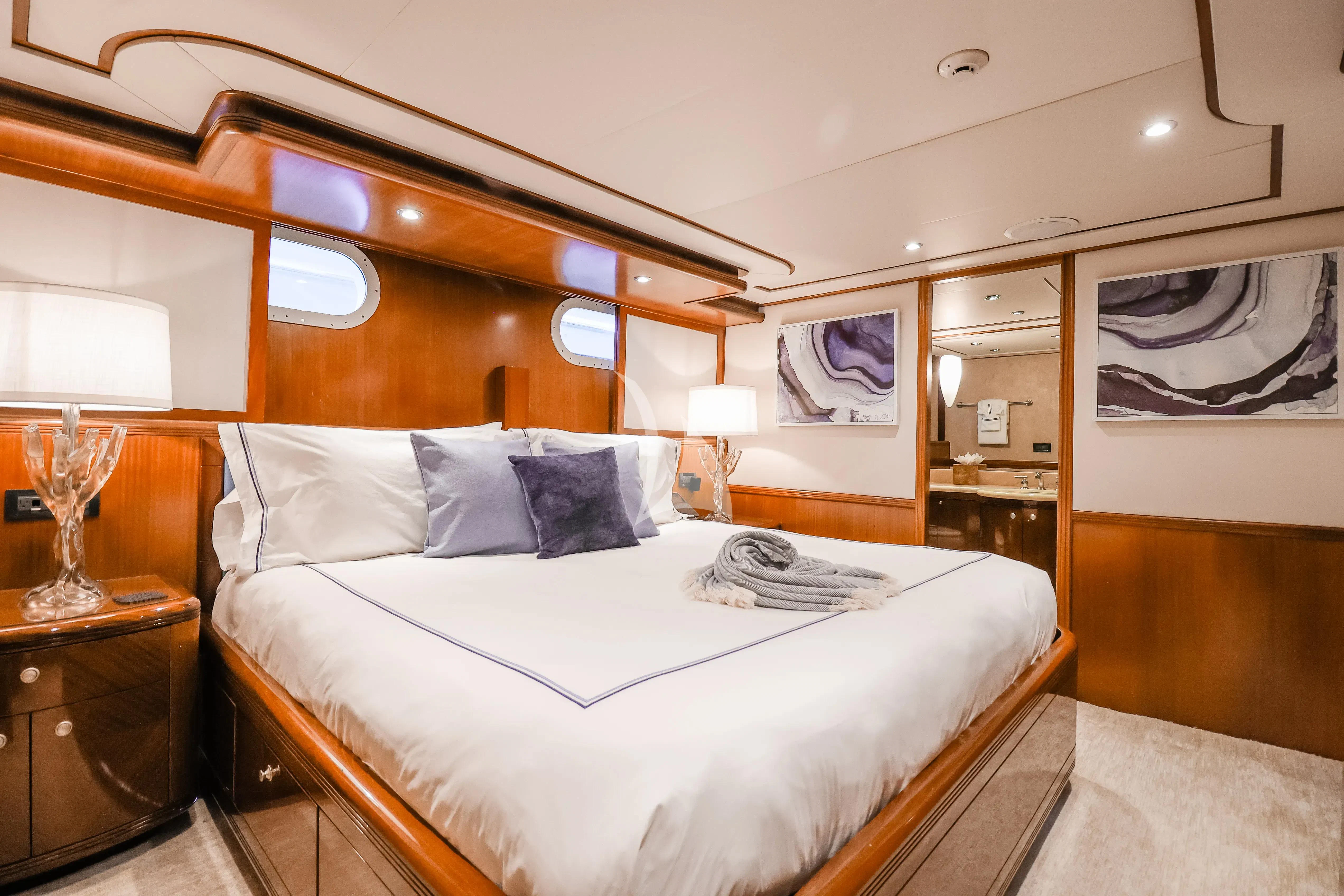 a bed with a white bed spread aboard JUST ENOUGH Yacht for Charter