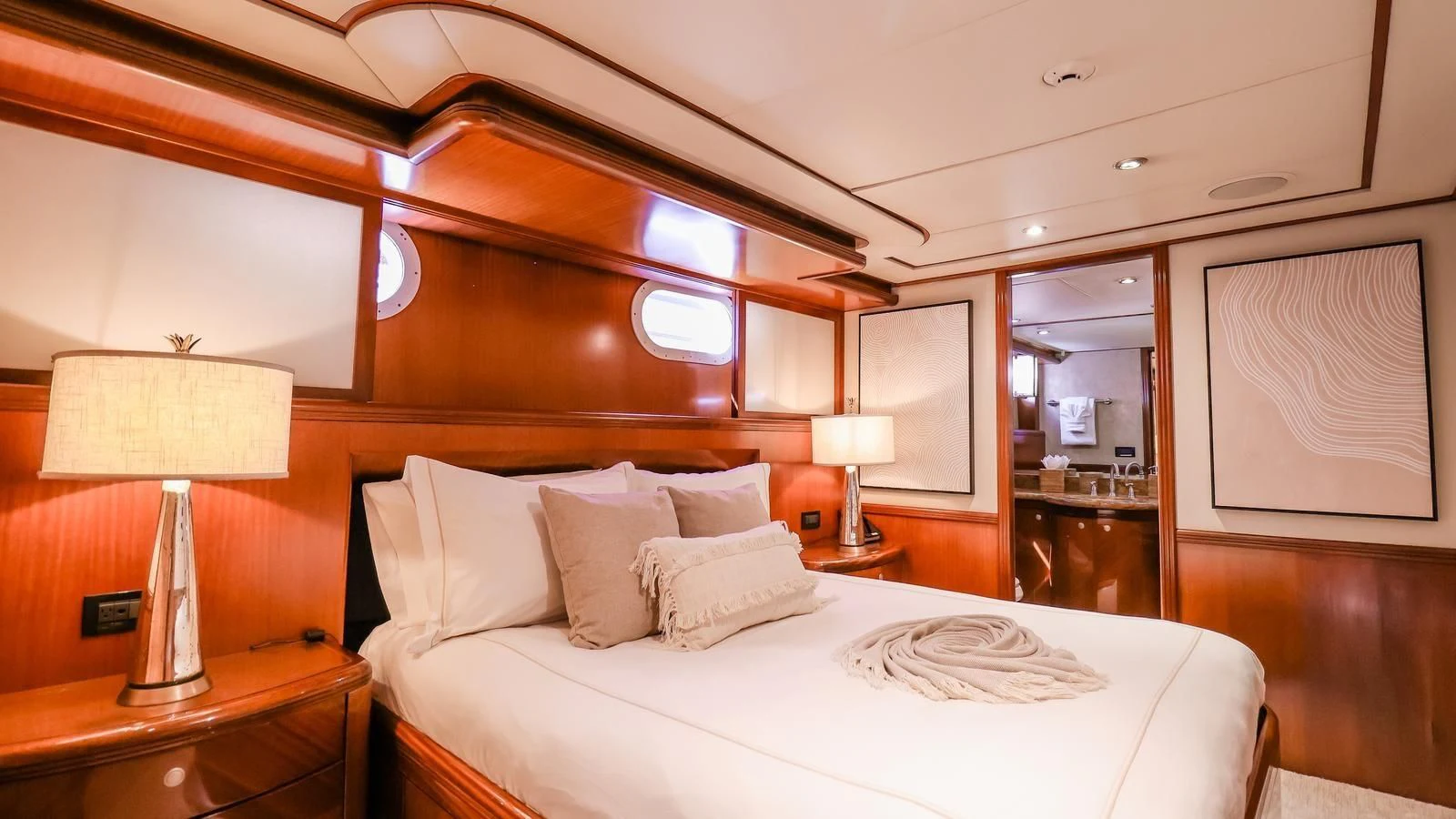a hotel room with a bed and lamps aboard JUST ENOUGH Yacht for Charter