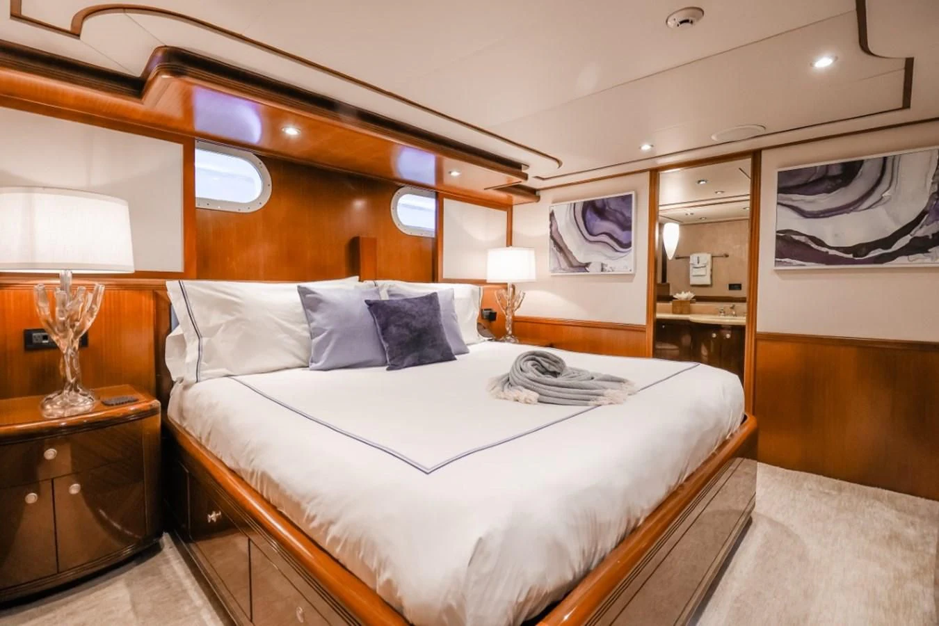 a bedroom with two lamps aboard JUST ENOUGH Yacht for Charter