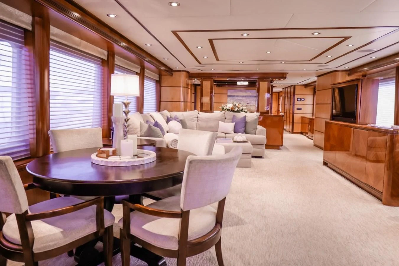 a large living room with a dining table and chairs aboard JUST ENOUGH Yacht for Charter