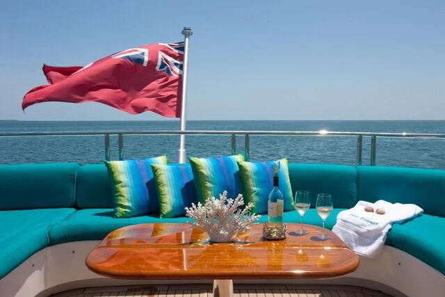 a couch with a flag on it aboard JUST ENOUGH Yacht for Charter