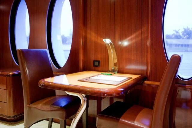 a table with chairs and a lamp aboard JUST ENOUGH Yacht for Charter