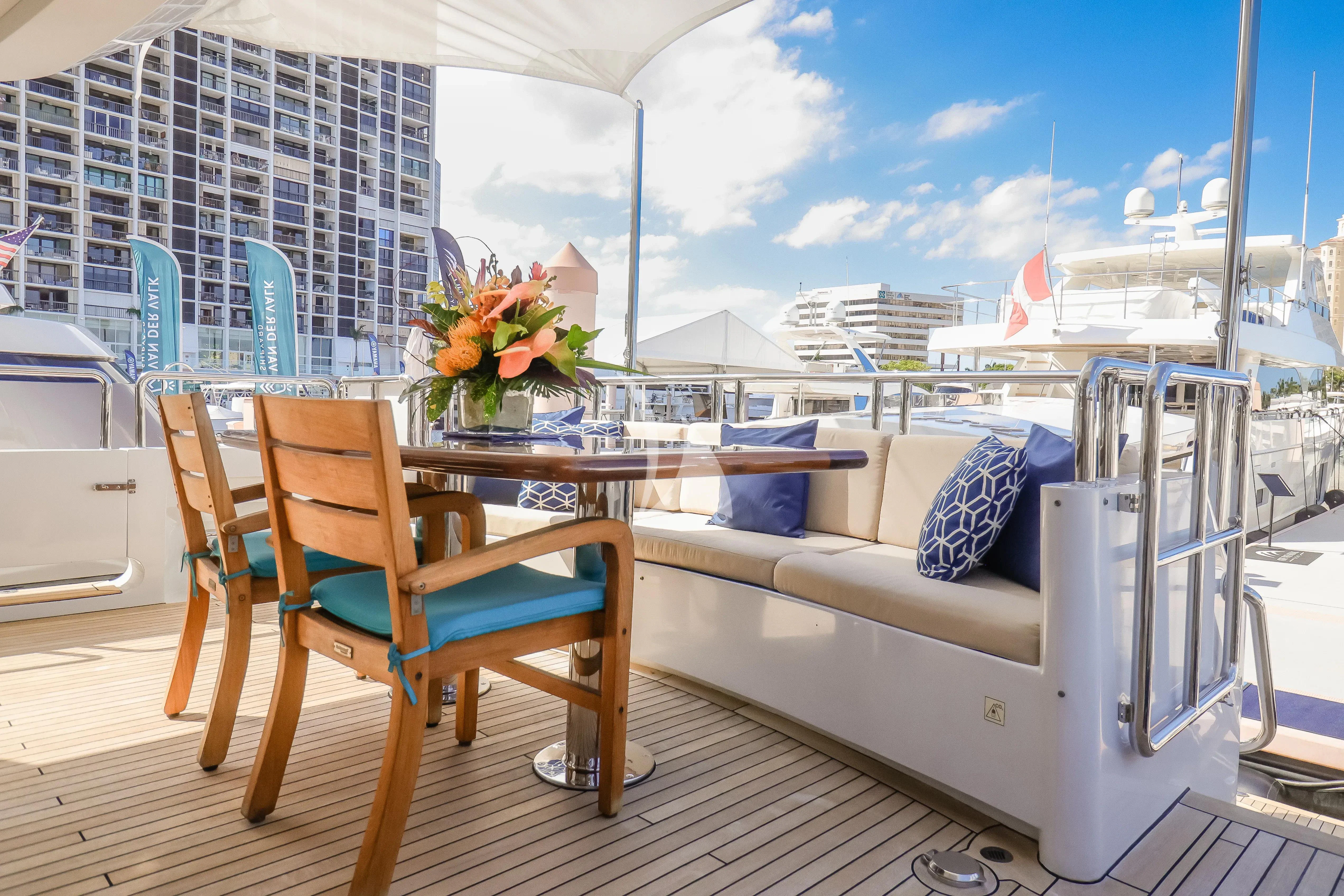 a table and chairs on a balcony aboard JUST ENOUGH Yacht for Charter