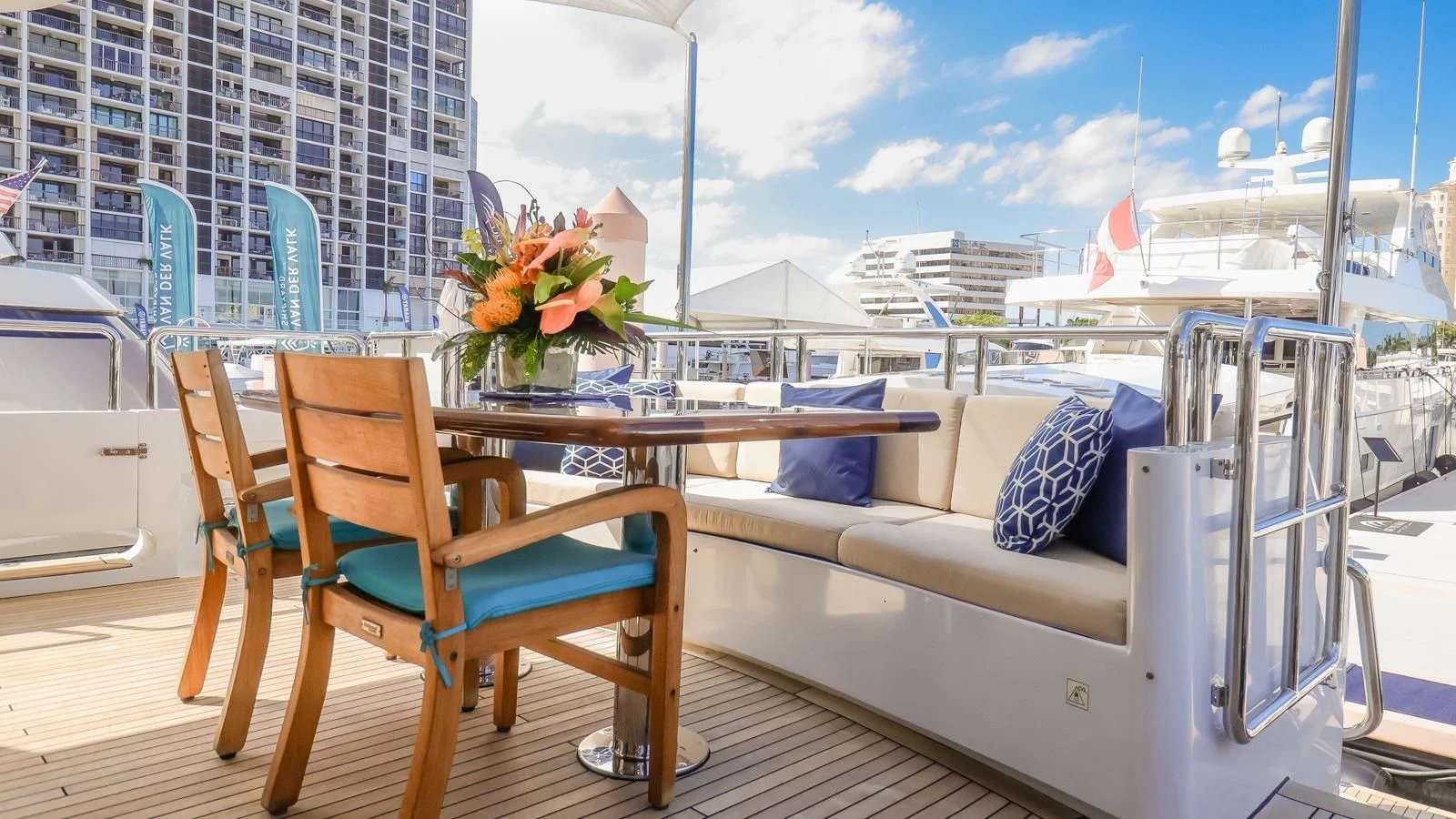 a table and chairs on a balcony aboard JUST ENOUGH Yacht for Charter