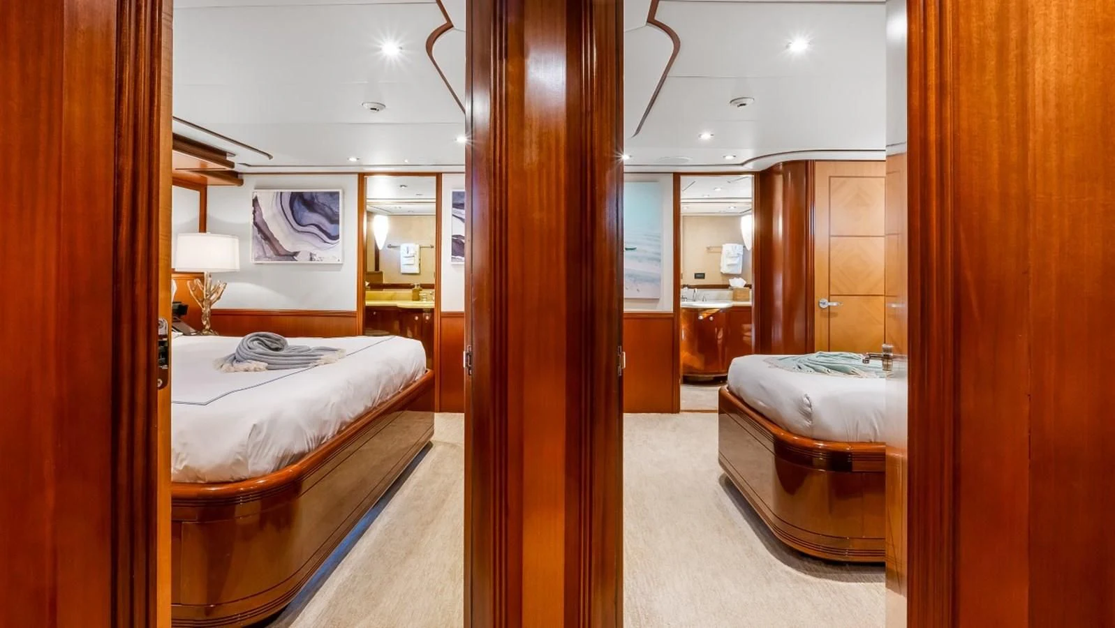 a room with a bed and a mirror aboard JUST ENOUGH Yacht for Charter