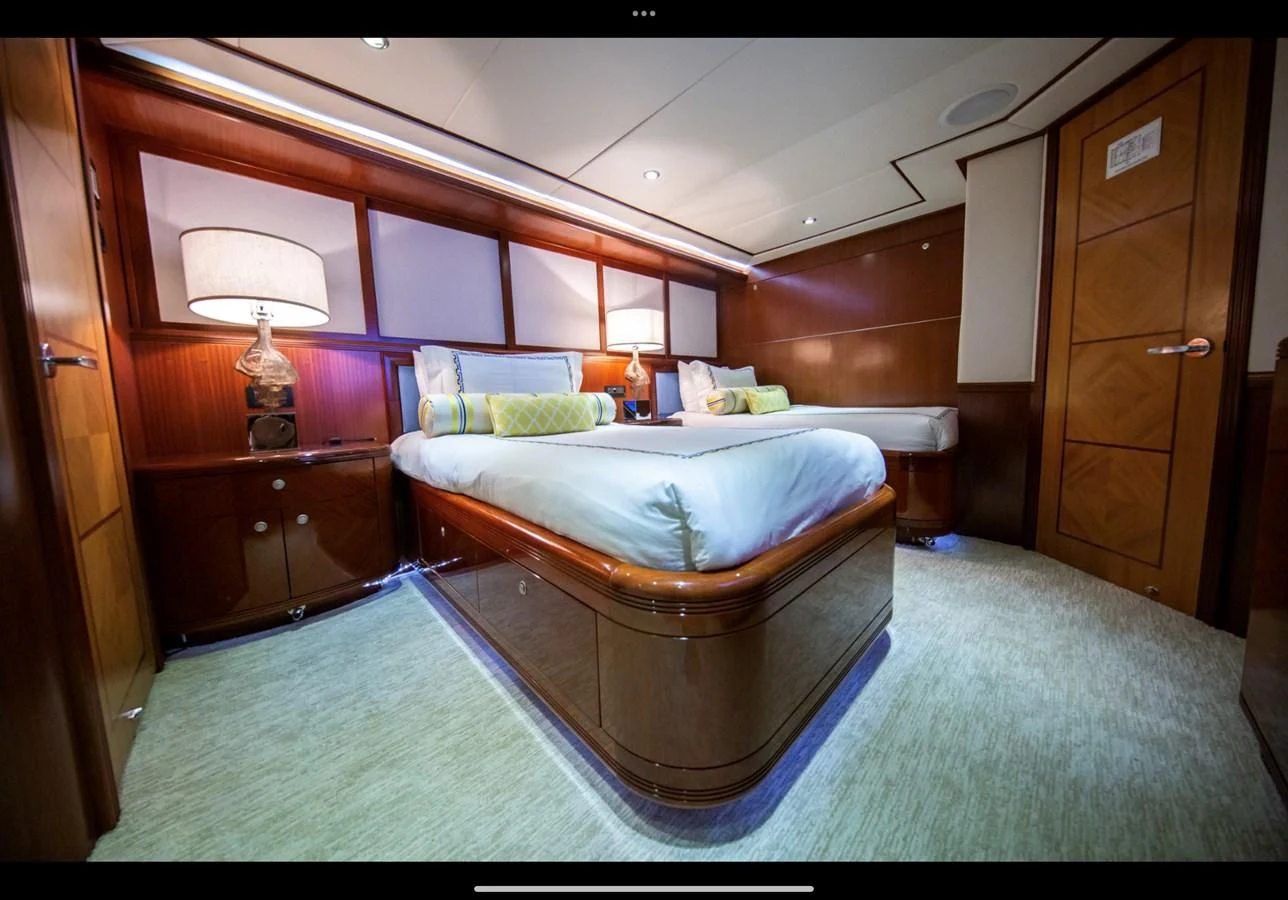 a bedroom with a bed and a desk aboard JUST ENOUGH Yacht for Charter