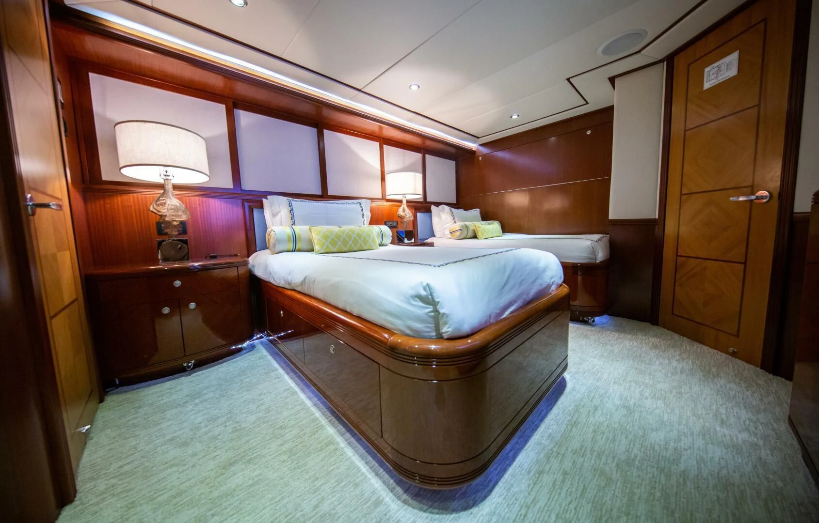 a room with a bed and a table aboard JUST ENOUGH Yacht for Charter