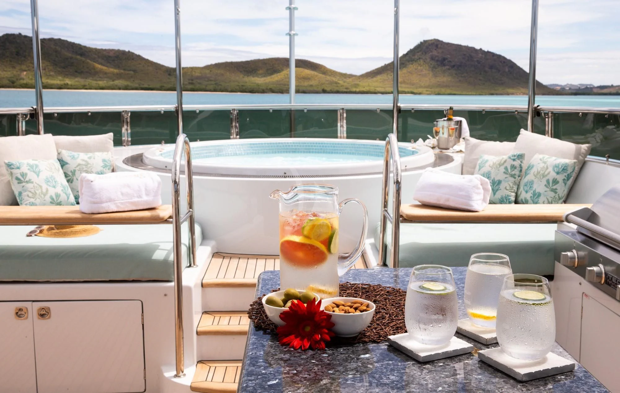 a table with drinks and food on it aboard JUST ENOUGH Yacht for Charter