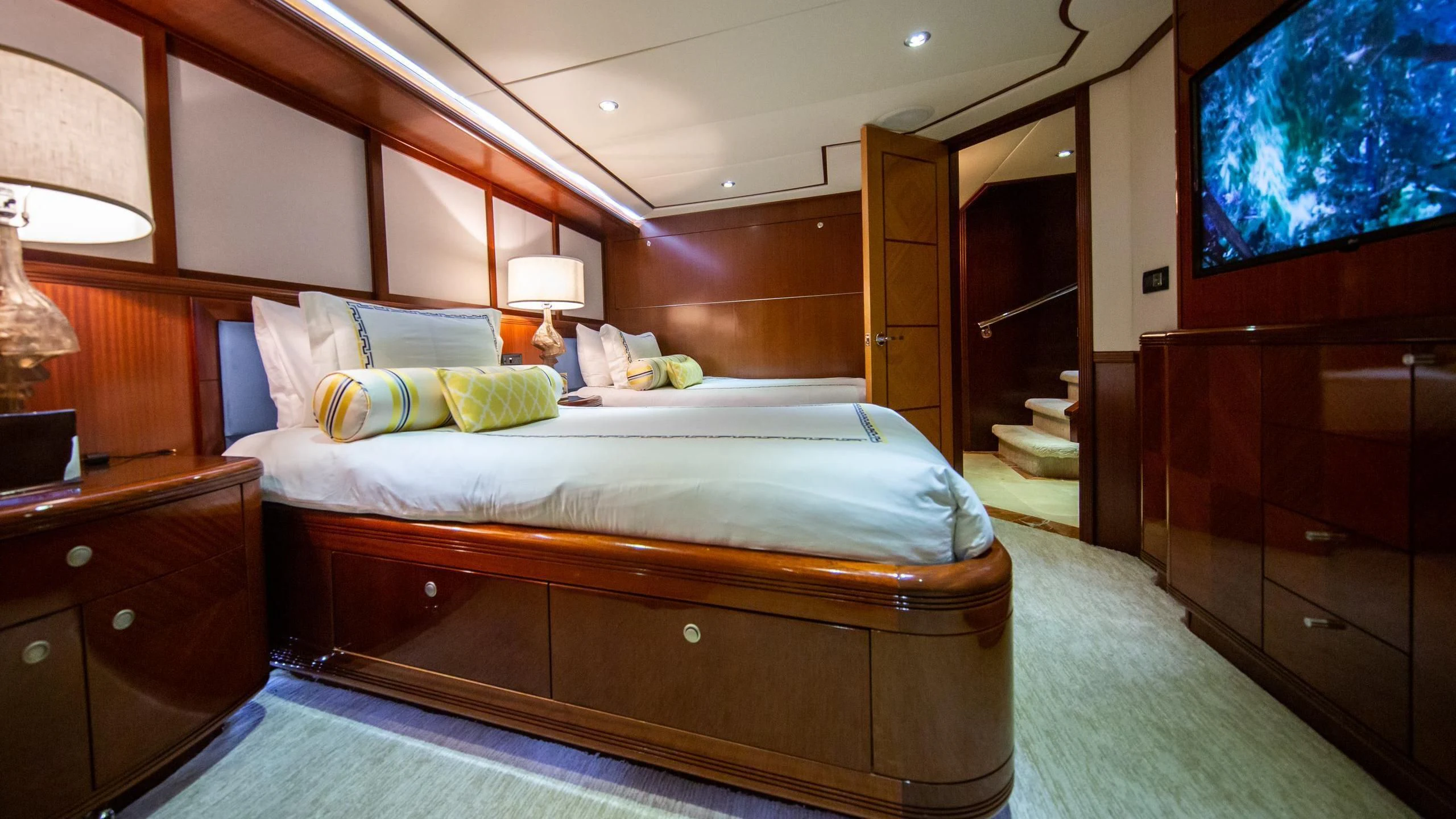 a bedroom with a bed and a desk aboard JUST ENOUGH Yacht for Charter