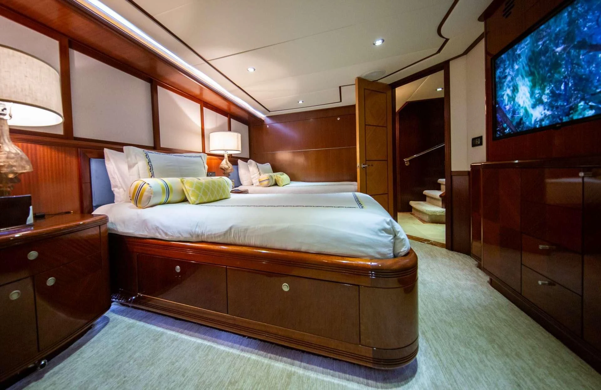 a bedroom with a bed and a dresser aboard JUST ENOUGH Yacht for Charter