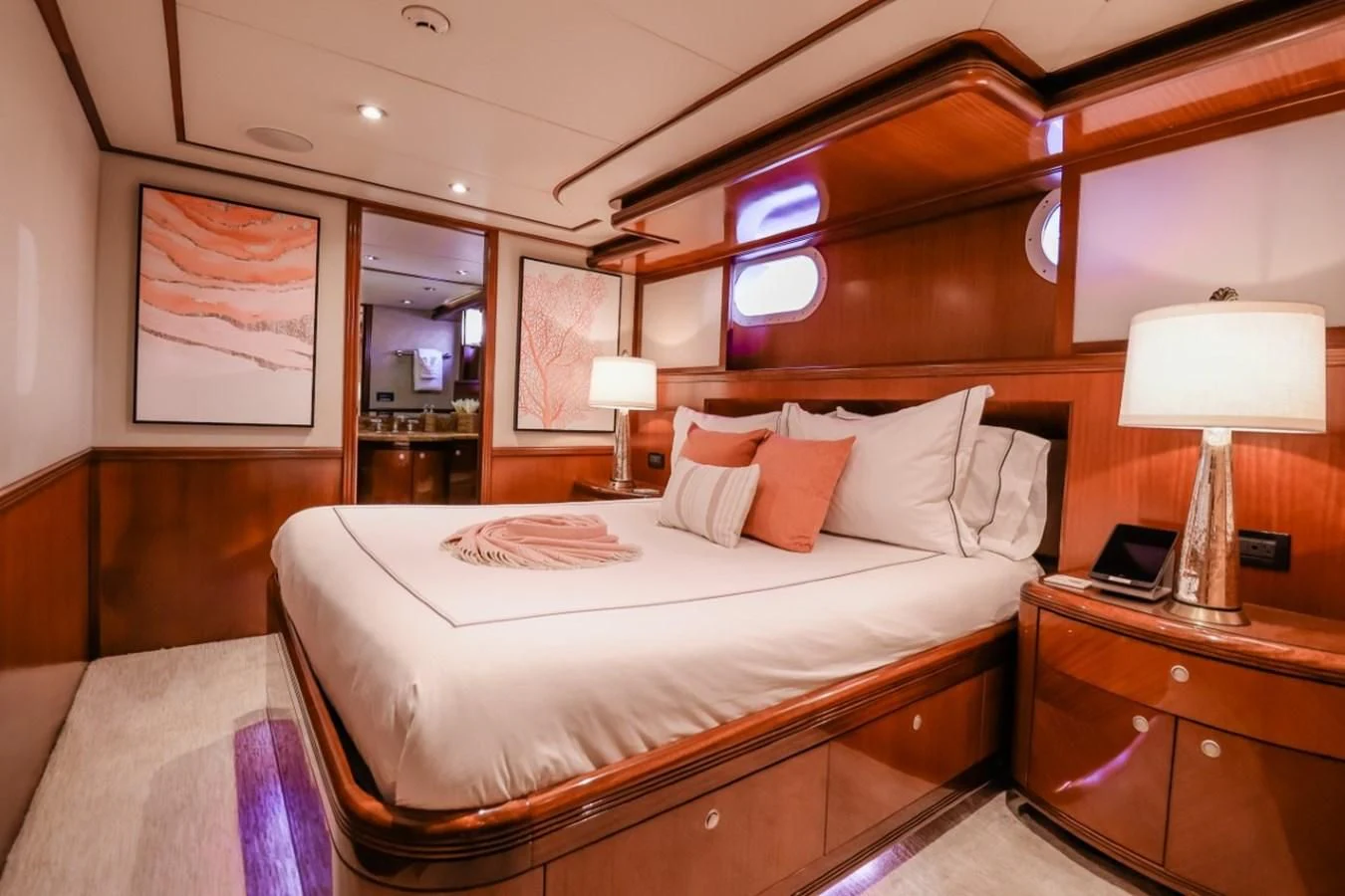 a bed with a white sheet and pillows on it aboard JUST ENOUGH Yacht for Charter