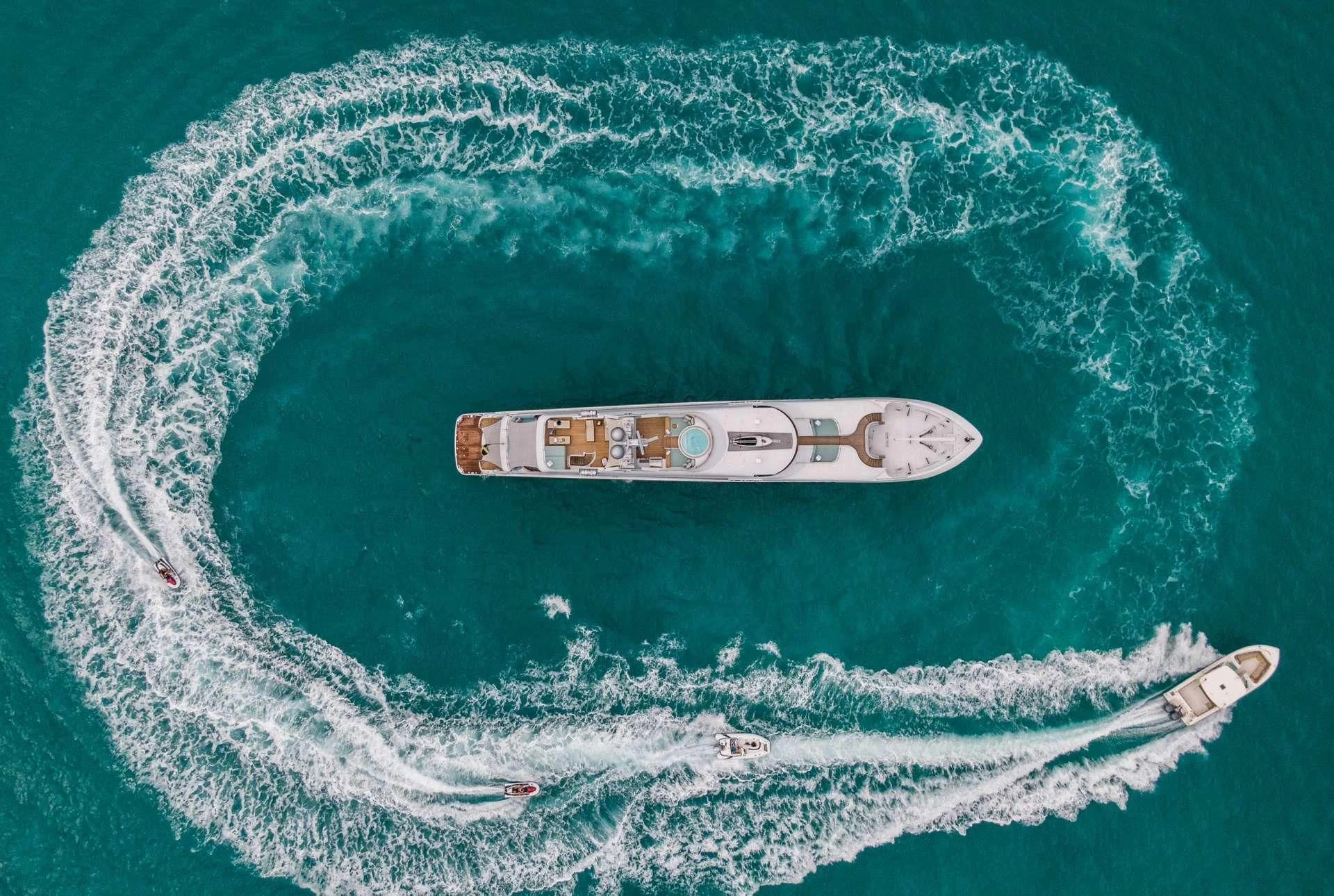 a white and black boat in the water aboard JUST ENOUGH Yacht for Charter