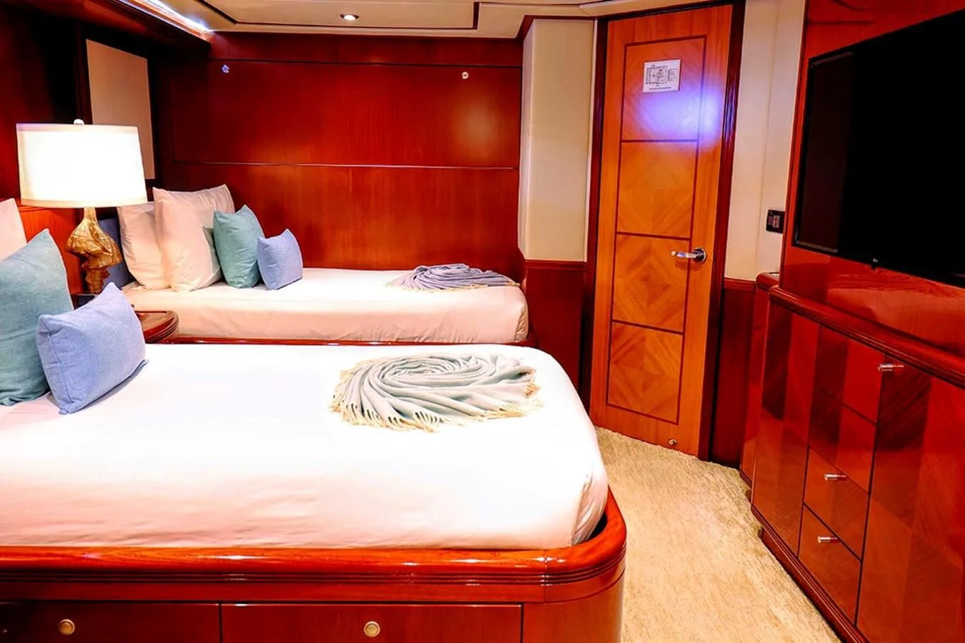 a bedroom with a bed and a desk aboard JUST ENOUGH Yacht for Charter