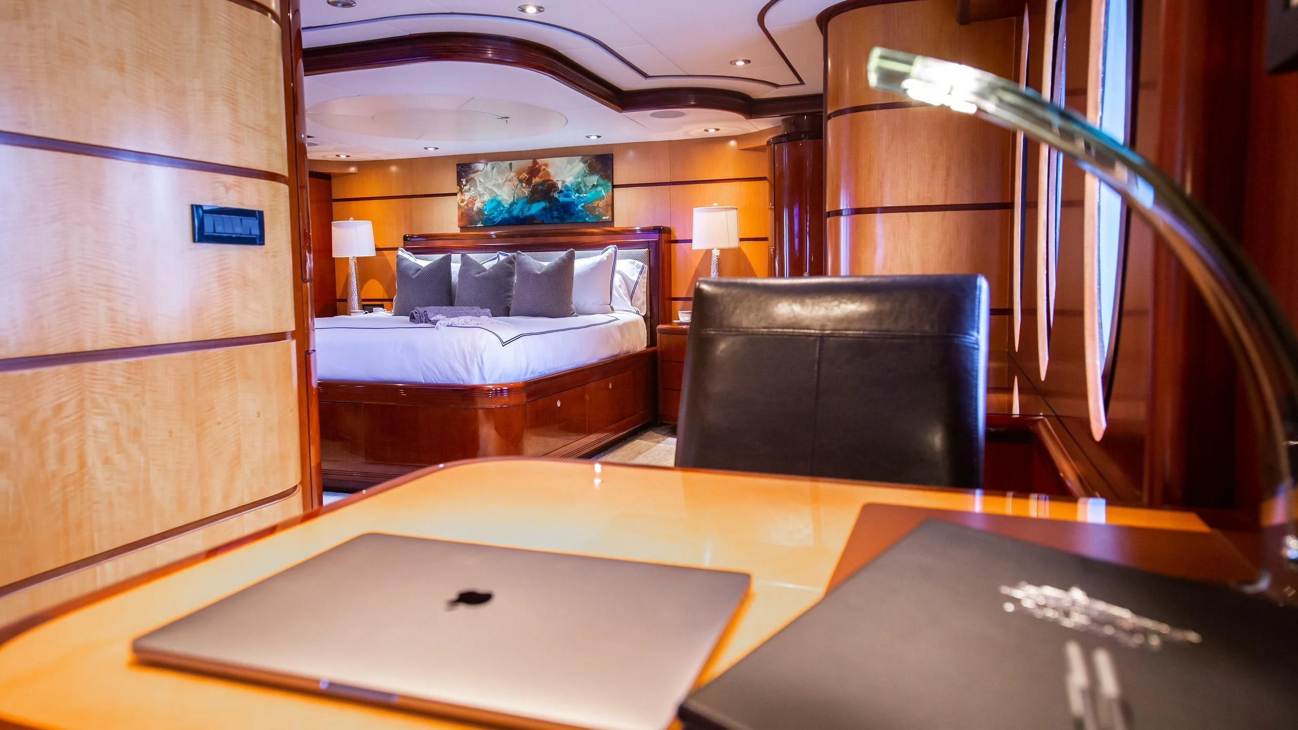 a room with a bed and a desk aboard JUST ENOUGH Yacht for Charter