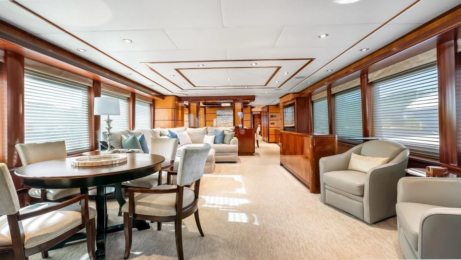 a large living room with a dining table and chairs aboard JUST ENOUGH Yacht for Charter