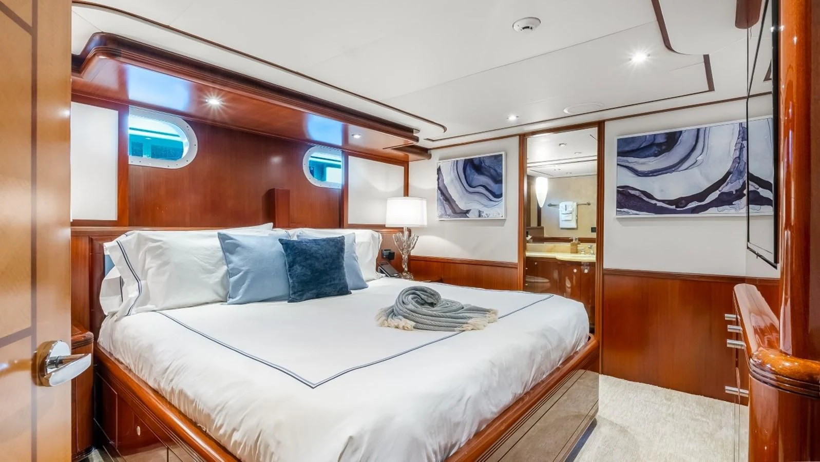 a room with a bed and a mirror aboard JUST ENOUGH Yacht for Charter