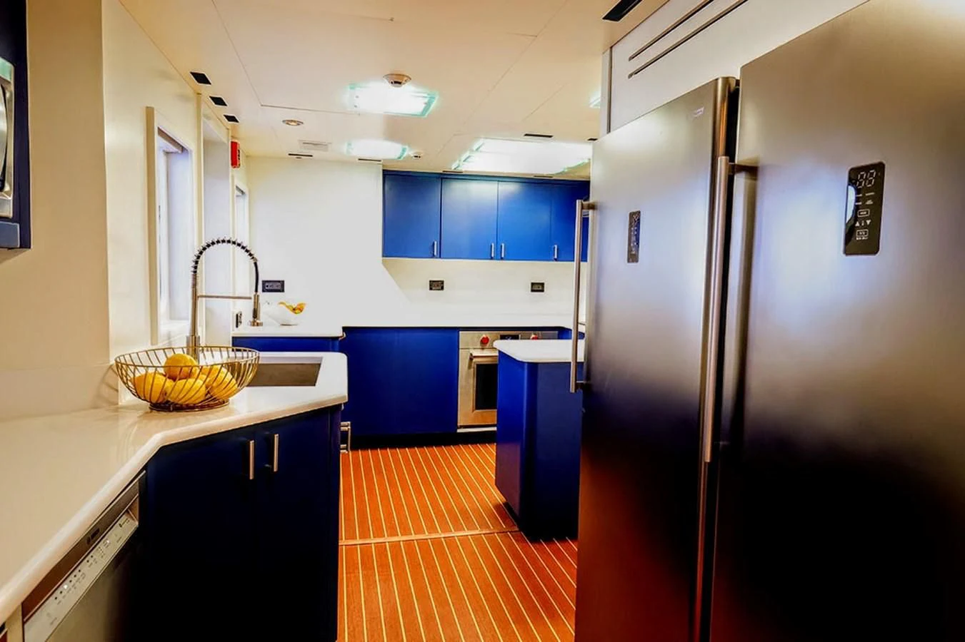 a kitchen with blue cabinets aboard JUST ENOUGH Yacht for Charter