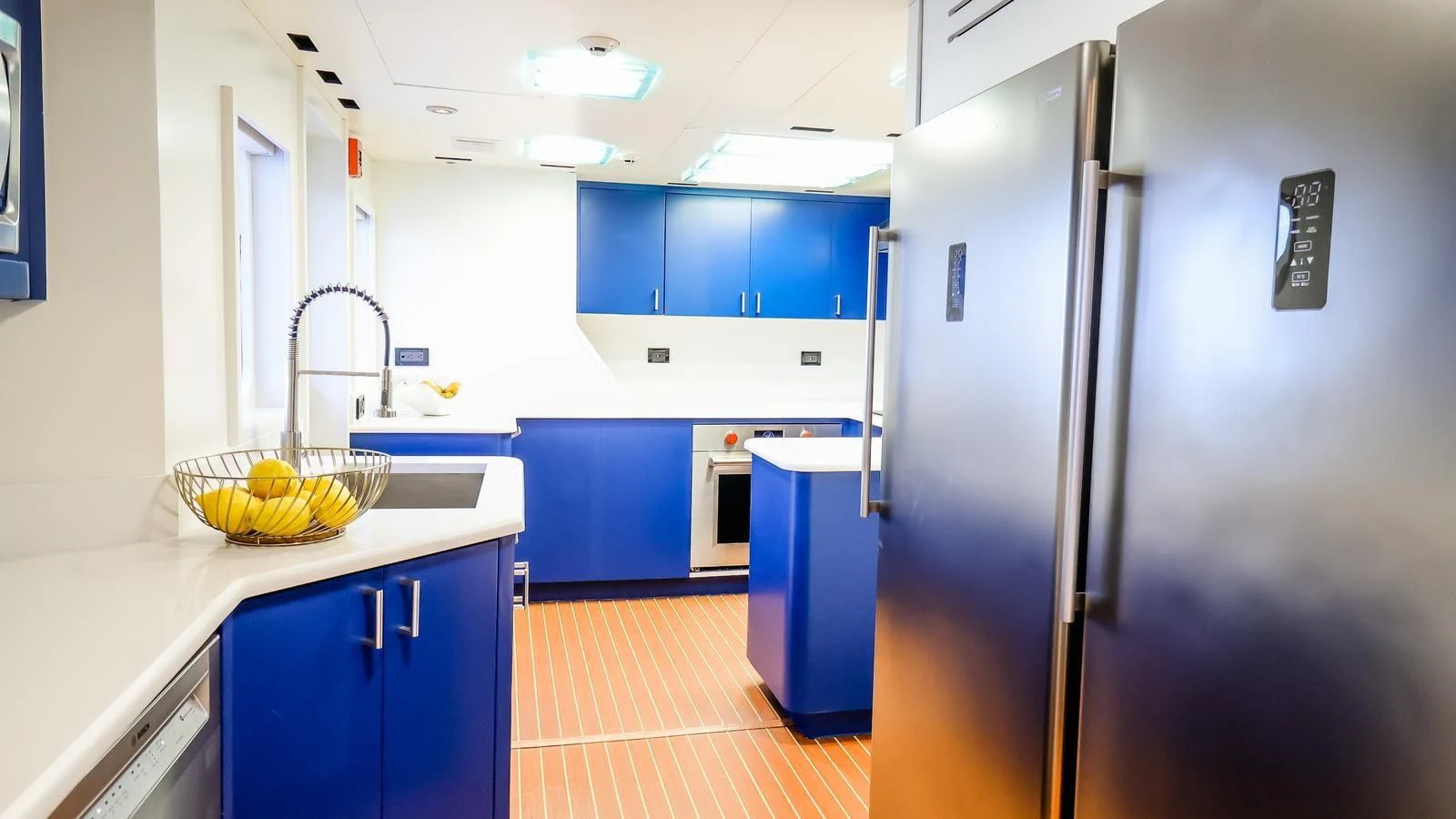 a kitchen with blue cabinets aboard JUST ENOUGH Yacht for Charter