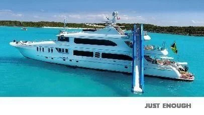 a large white boat in the water aboard JUST ENOUGH Yacht for Charter