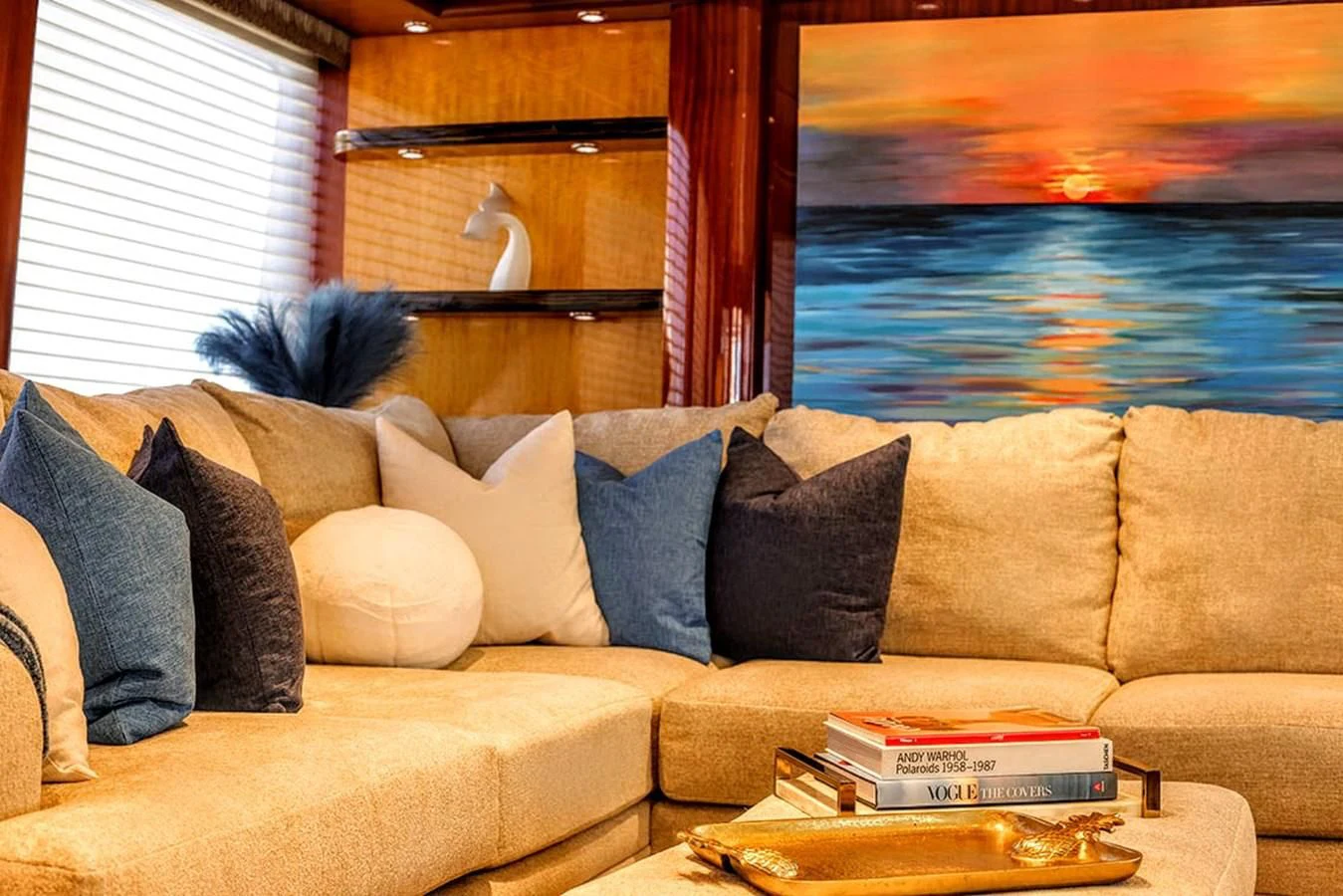 a couch with pillows and a fish tank in the background aboard JUST ENOUGH Yacht for Charter