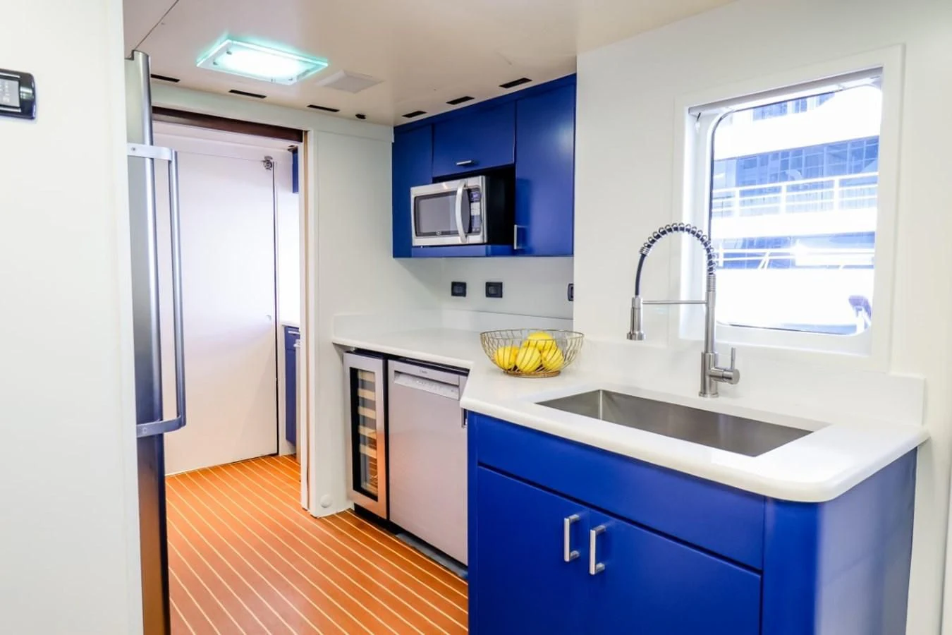 a kitchen with blue cabinets aboard JUST ENOUGH Yacht for Charter
